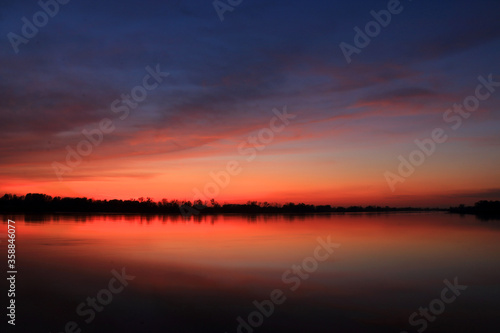 Colorful sunset by the Odra River, Poland. © Dariusz