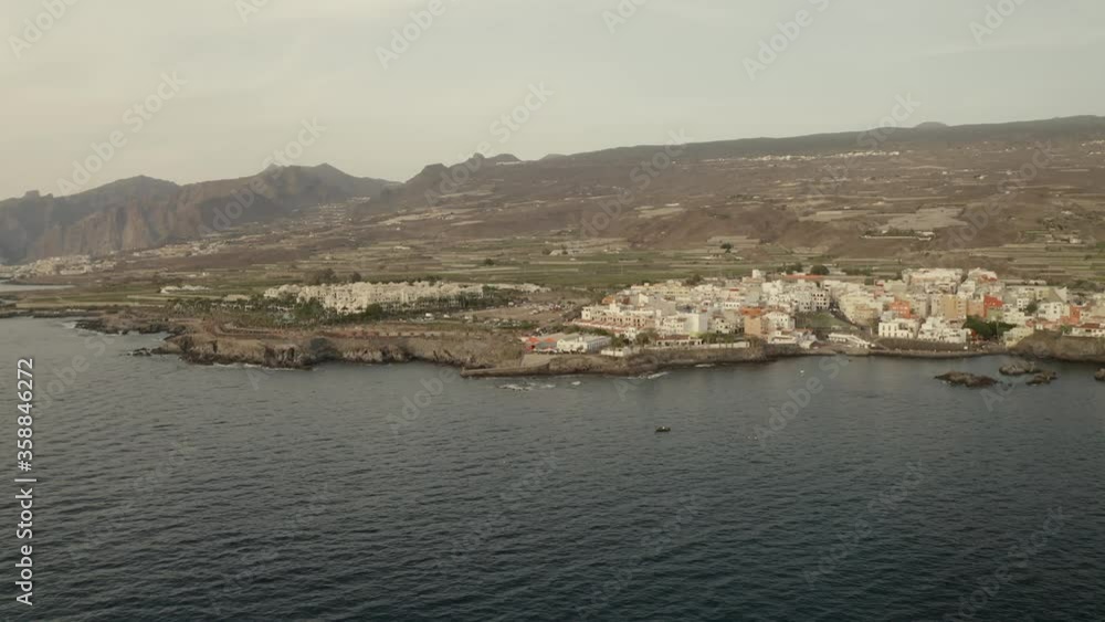 A city on the coast of Tenerife Island, surrounded by the Atlantic Ocean and mountains. Spain, Canary Islands. View from above A city on the coast of Tenerife Island, surrounded by the Atlantic Ocean and mountains. Spain, Canary Islands. View from above
