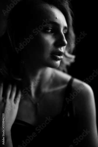 Close up monochrome portrait of curly blond charming woman.