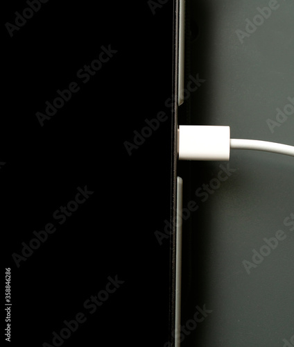 USB C cable connected for connecting, charging and syncing computer technology..