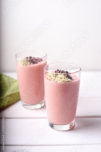 Two strawberry raspberry smoothies with hemp seed topping
