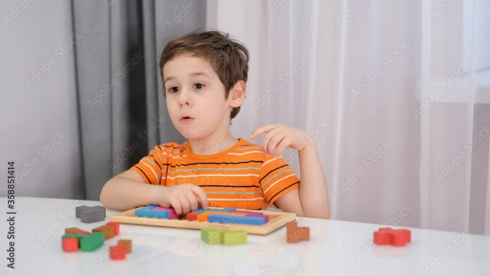 Close up of child's hands playing with colorful wooden bricks at the table. stock footage. Slow Motion video. Close up Close up of child's hands playing with colorful wooden bricks at the table. stock footage. Slow Motion video. Close up