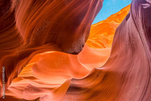 The morning sunshine causes the high walls of the canyon to glow in lower Antelope Canyon, Page, Arizona