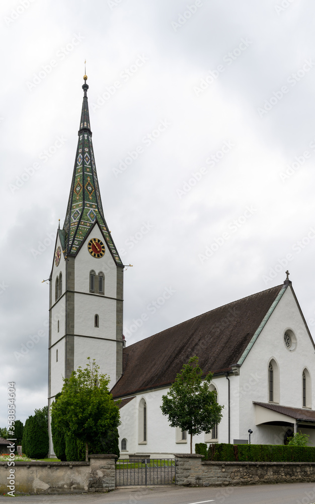view of the historic catholic church Saint Maurice in the Swiss village of Sommeri