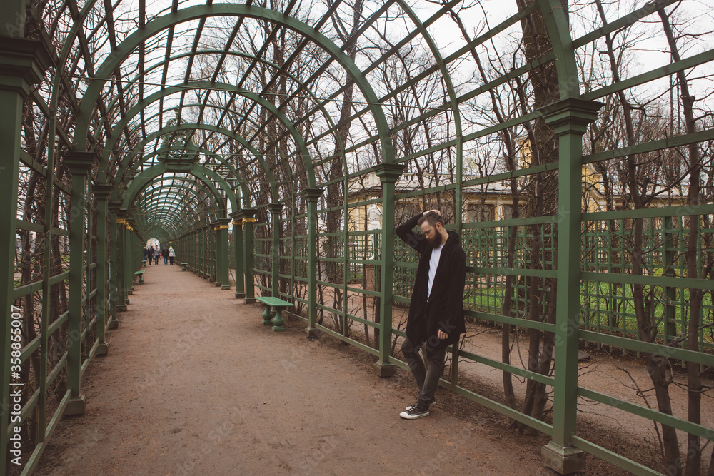 Man in the mantle in a city park Man in the mantle in a city park