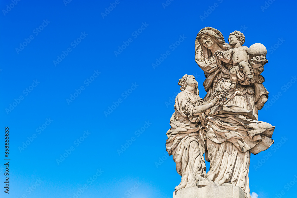 Statue of Saint Anne Matej Vaclav Jackel on the north side of Charles Bridge over the river Vltava; statue of a woman with two children in Prague, Czech Republic