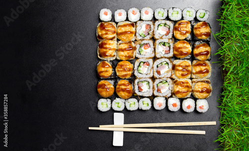 Sushi. Bonito rolls, classic and bake rolls on the dark background. Sushi food photo for menu. Combo set of rolls Sushi