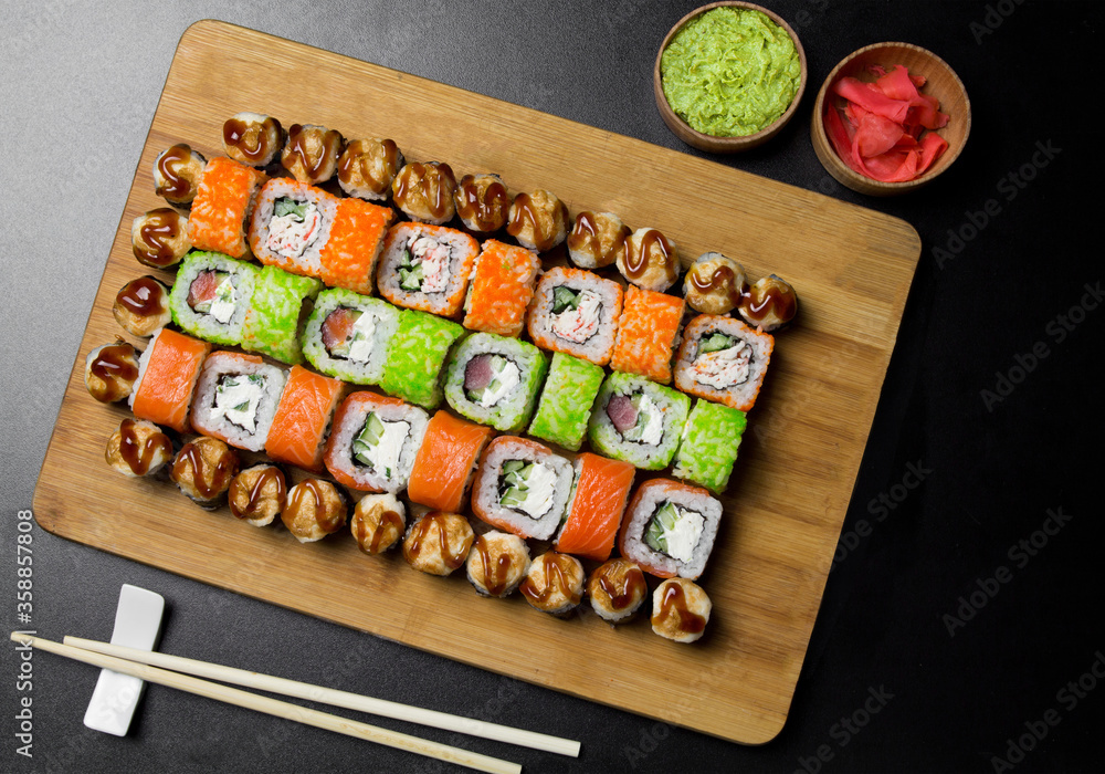 Sushi Philadelphia rolls, California, Miami rolls and bake the classic rolls on Board made of bamboo. Sushi food photo for menu. Combo set of rolls Sushi Sushi Philadelphia rolls, California, Miami rolls and bake the classic rolls on Board made of bamboo. Sushi food photo for menu. Combo set of rolls Sushi