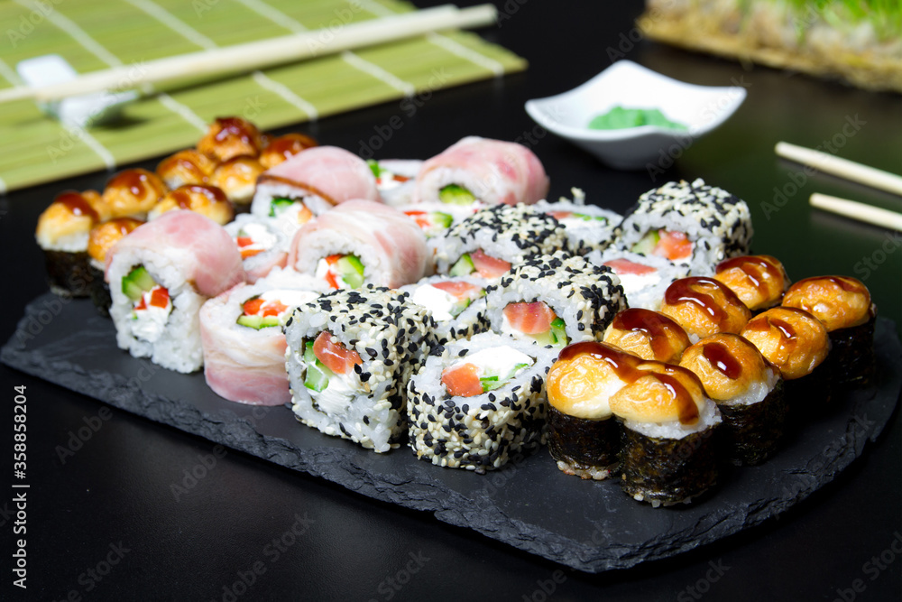 Sushi. Venice rolls, Texas rolls and bake rolls on the dark background. Sushi food photo for menu. Combo set of rolls Sushi Sushi. Venice rolls, Texas rolls and bake rolls on the dark background. Sushi food photo for menu. Combo set of rolls Sushi
