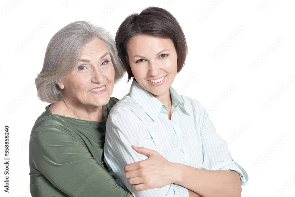 Mother and her adult daughter hugging isolated on white Mother and her adult daughter hugging isolated on white