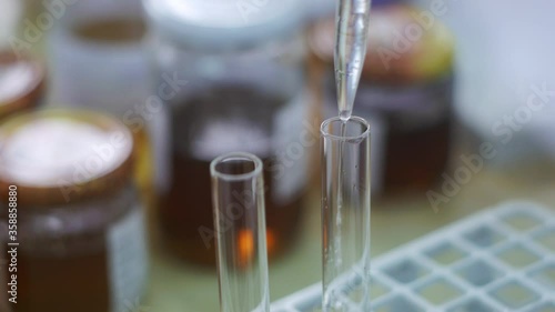 test tube with liquid,  laboratory processing of samples, pipetting of samples into test tubes, very close up shot photo