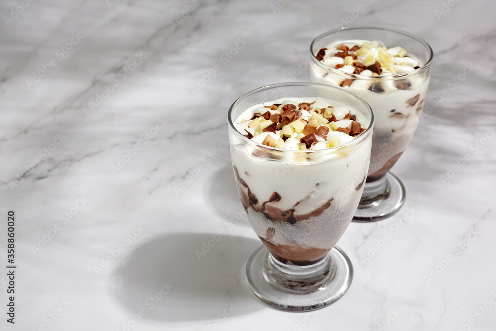 Two glasses with ice cream on marble background. Summer background Two glasses with ice cream on marble background. Summer background
