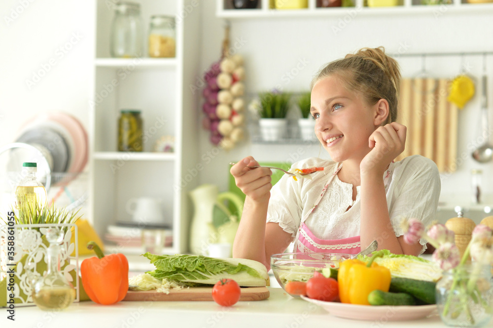 Portrait of cute girl cooking salad on kitchen Portrait of cute girl cooking salad on kitchen