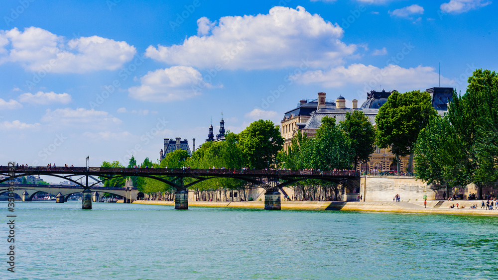 Fototapeta premium It's Pont des Arts or Passerelle des Arts, a pedestrian bridge in Paris which crosses the Seine River.