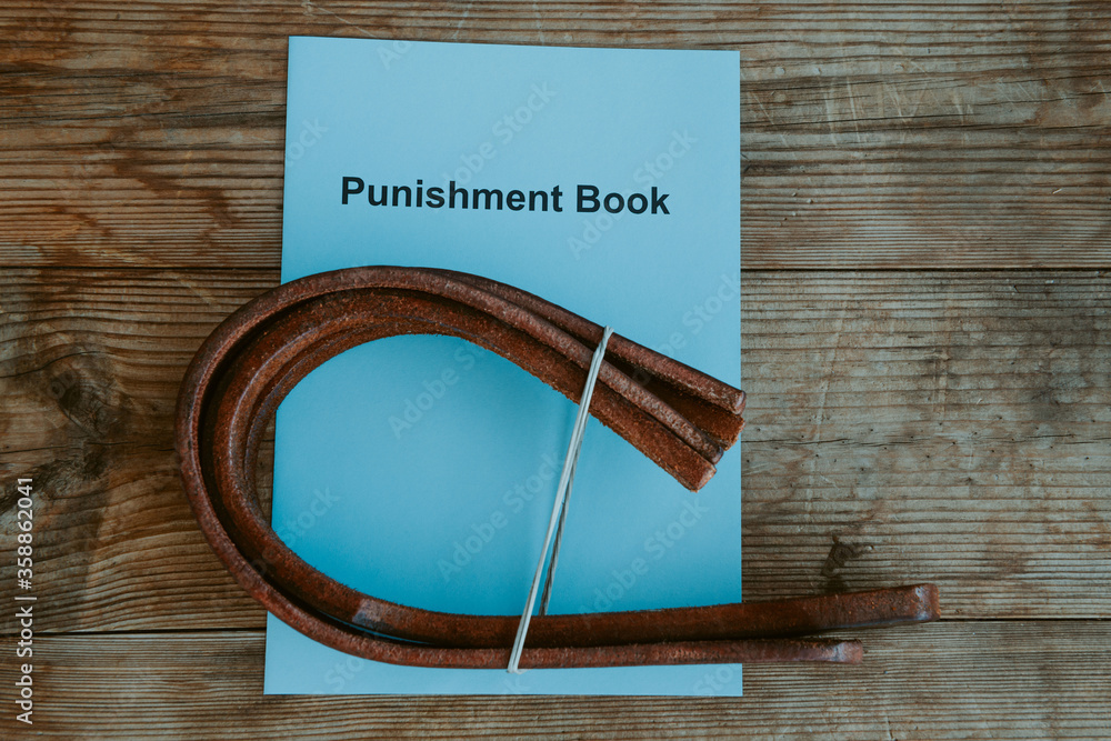Punishment book. Leather tawse for spanking on headmaster's or teacher's  desk. School corporal punishment. Discipline and spanking in school. Adult  role play. Spanking implements, bdsm toys Stock Photo | Adobe Stock