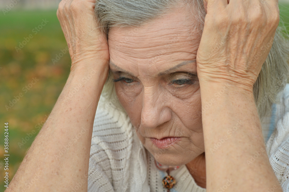 Portrait of sad, thoughtful senior woman in park Portrait of sad, thoughtful senior woman in park