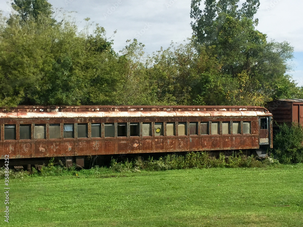Abandoned rusted railroad car with overgrown weeds Abandoned rusted railroad car with overgrown weeds