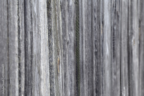 Fence of boards in defocus as background or texture.