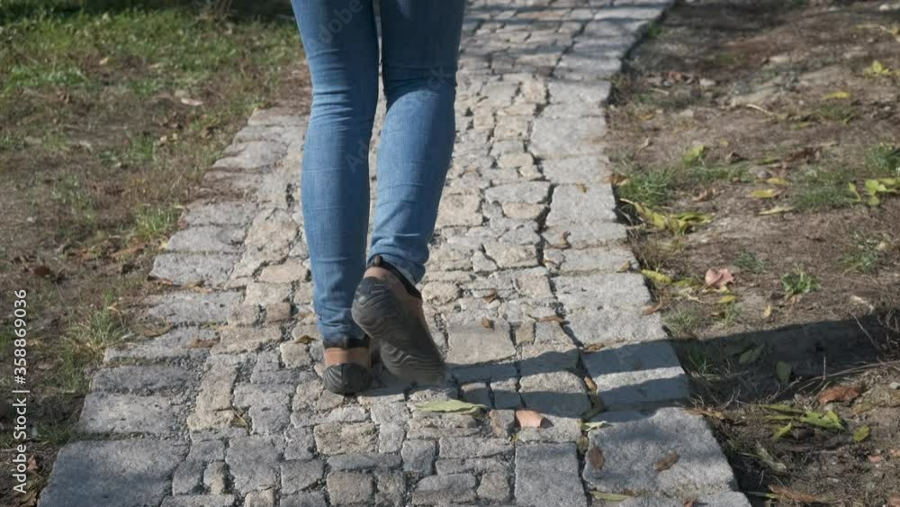Walk along the old cobblestones. Legs walking along a cobbled path. Walk along the old cobblestones. Legs walking along a cobbled path.