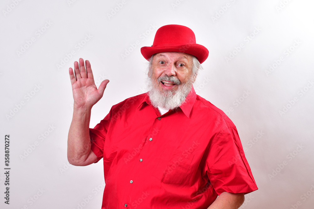 Cheerful gentleman giving the open hand greeting gesture..Happy old man with a red bowler hat giving the greeting wave. Cheerful gentleman giving the open hand greeting gesture..Happy old man with a red bowler hat giving the greeting wave.