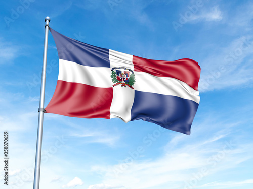 Dominican Republic flag on a pole against a blue sky background.