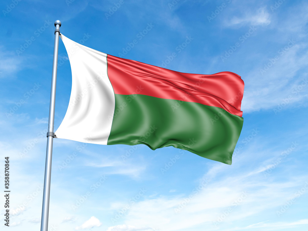 Naklejka premium Madagascar flag on a pole against a blue sky background.