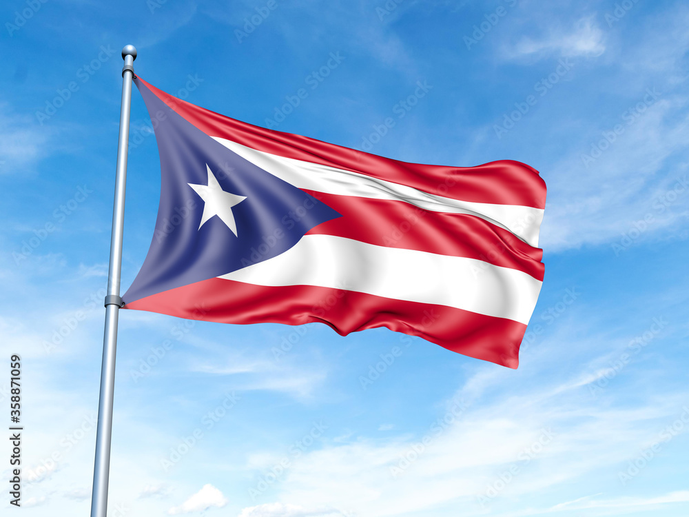 Puerto Rico flag on a pole against a blue sky background.