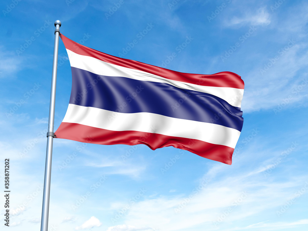 Thailand flag on a pole against a blue sky background.