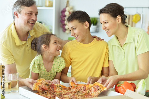 Portrait of big happy family eating pizza together