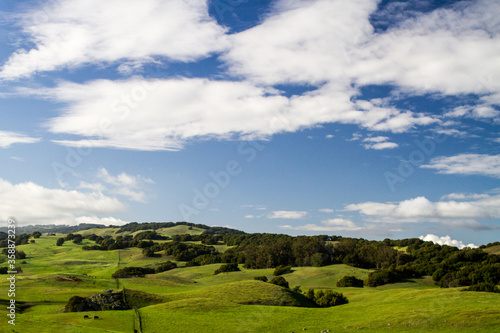 Wide Open - Clouds and bright green rolling hills are pumped up by rains. Napa County  California  USA