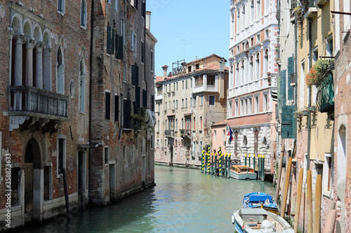 island of Venice in Italy with the navigable canal and moored bo