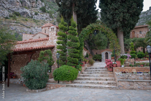 Blooming azaleas in ancient monastery of Kesariani in mountains near Athens, Greece photo