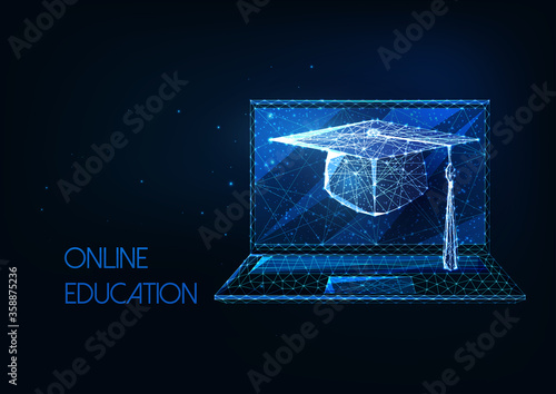 Futuristic online education, distance learning concept with glowing low polygonal graduation cap and laptop