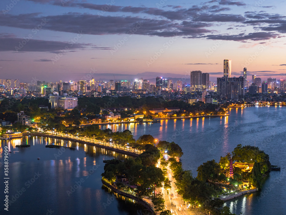 Aerial view of Hanoi skyline showing West Lake and Tay Ho District at dusk in Hanoi, Vietnam.