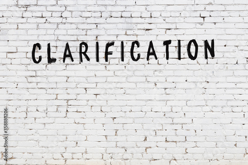 Fotografi Word clarification painted on white brick wall
