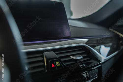 a middle console of a modern car with big enterteiment navigation screen.