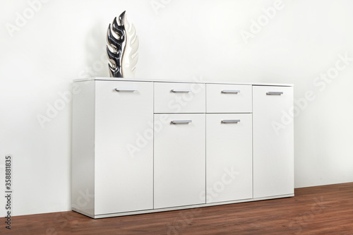 Stylish white chest of drawers on a white background. Dressing room furniture