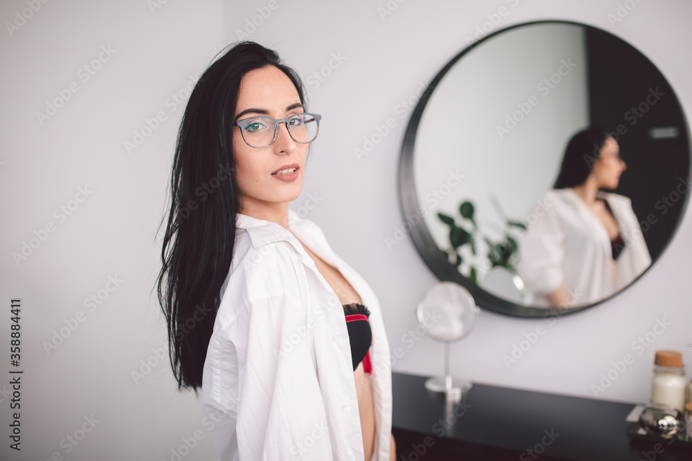 Fashion luxury lady in man shirt. Beauty woman in lingerie and shirt posing at bedroom near mirror. Trendy portrait of seductive sexy girl model in underwear. Sexy Young Woman In Lingerie Posing Fashion luxury lady in man shirt. Beauty woman in lingerie and shirt posing at bedroom near mirror. Trendy portrait of seductive sexy girl model in underwear. Sexy Young Woman In Lingerie Posing