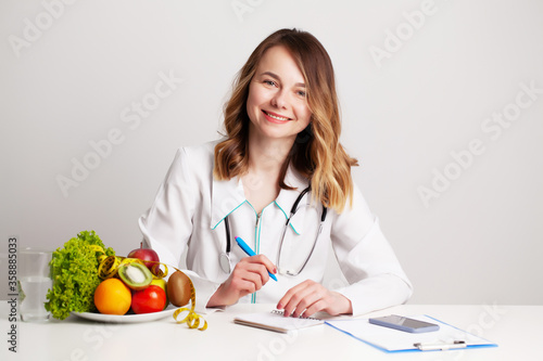 Nutritionist makes a diet plan for proper nutrition for the patient in his office