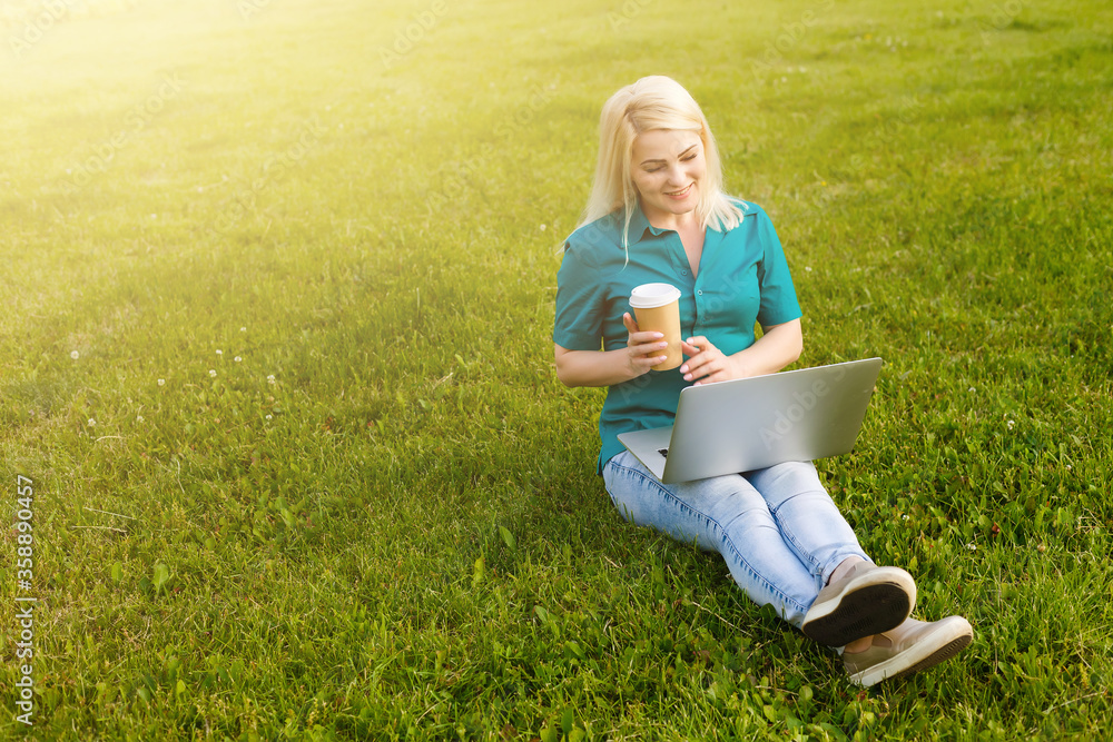 woman searching job with a laptop in an urban park in summer woman searching job with a laptop in an urban park in summer