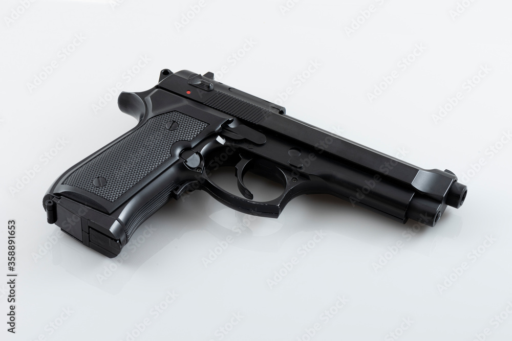 Black pistol gun isolated on the white background.