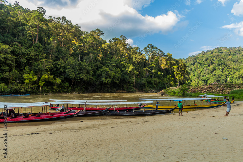 TAMAN NEGARA, MALAYSIA - MARCH 17, 2018: Boats at the Tembeling river in Taman Negara national park. TAMAN NEGARA, MALAYSIA - MARCH 17, 2018: Boats at the Tembeling river in Taman Negara national park.