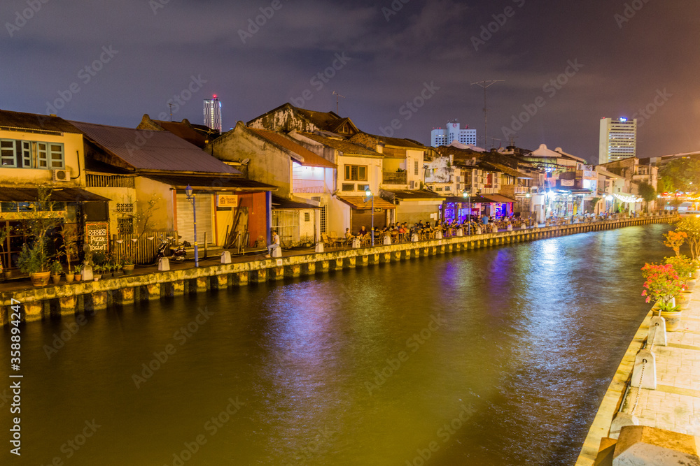 MALACCA, MALAYASIA - MARCH 18, 2018: Night view of Malacca river in the center of Malacca (Melaka).