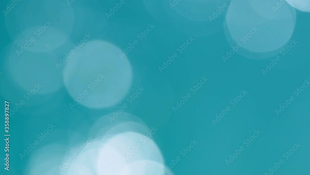 Beautiful sparkling shiny texture of blurry blue water with sun reflected on surface of water Beautiful sparkling shiny texture of blurry blue water with sun reflected on surface of water