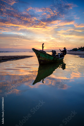 traditional fisherman boat at sunrise