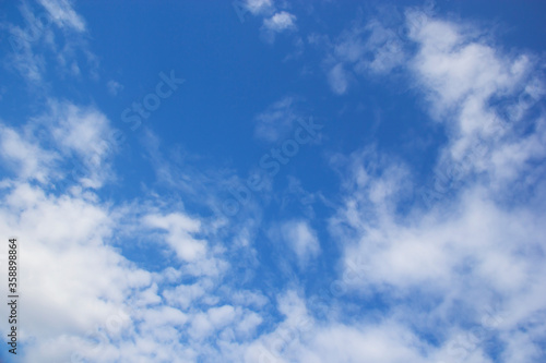 Blue sky background and white clouds soft focus, and copy space