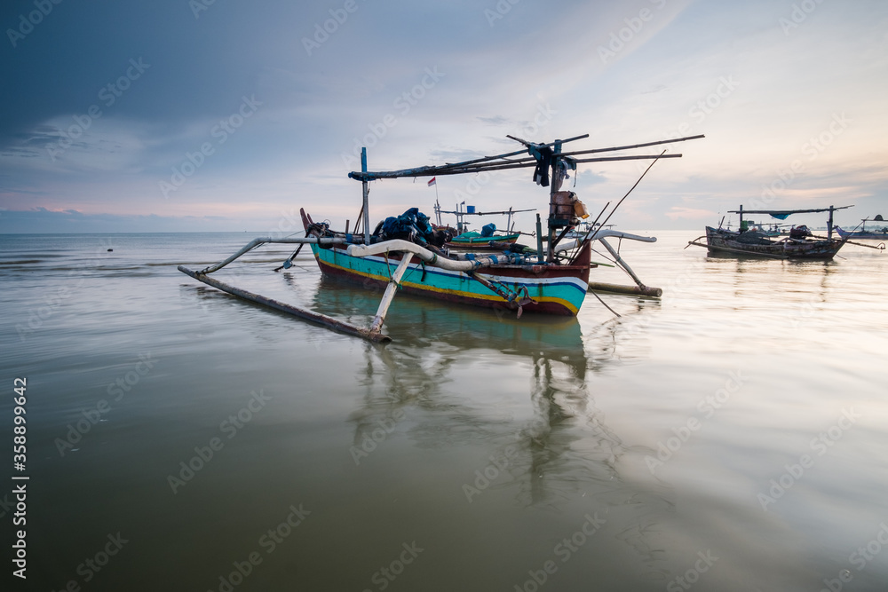 traditional fisherman boat at sunrise