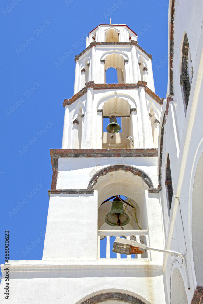 An arched bell tower in the traditional village of Megalochori in Santorini, Greece.