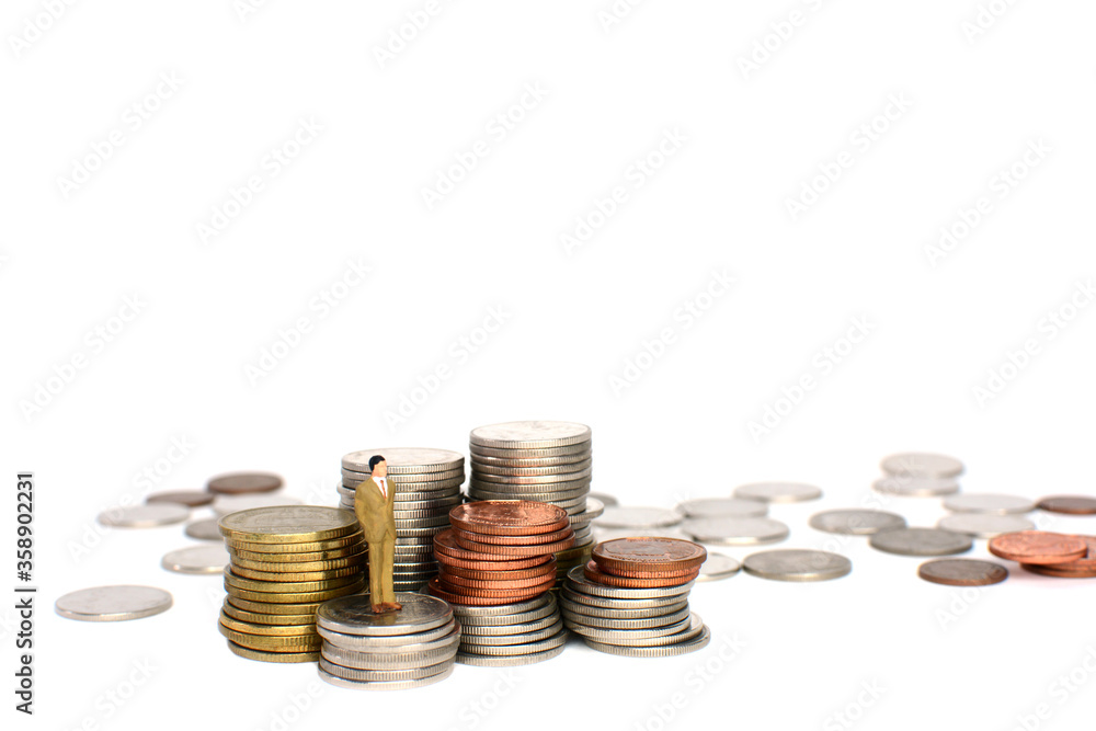 Miniature figures businessman on coins, on the white backgroud. Miniature figures businessman on coins, on the white backgroud.