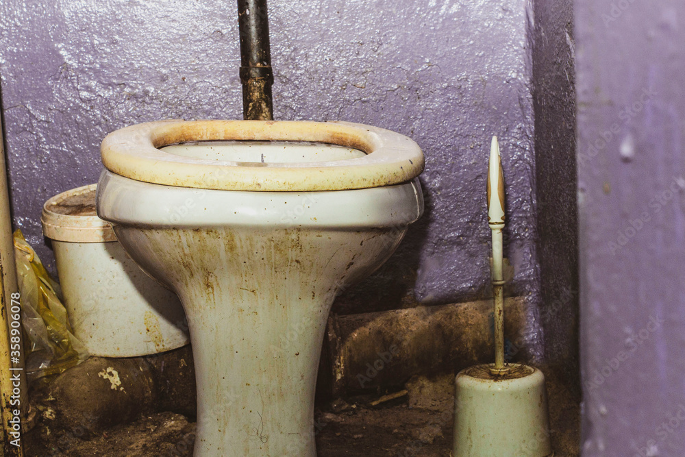 Dirty unhygienic toilet bowl with limescale stain at public restroom Dirty unhygienic toilet bowl with limescale stain at public restroom